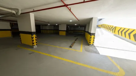 Modern bir sitenin geniş ve düzenli açık ve kapalı otopark alanı.