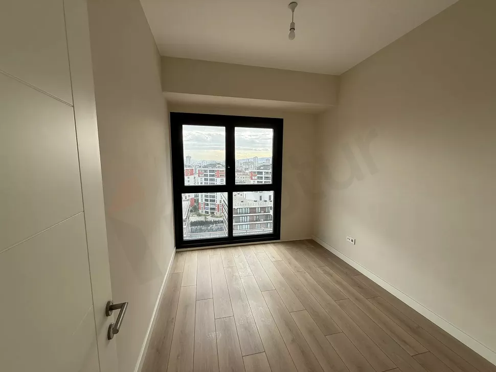 Modern mimariye sahip, gün ışığı alan geniş ve ferah bir yatak odası alanı.