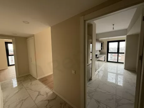 Modern bir apartman dairesinin geniş ve aydınlık koridor görünümü.