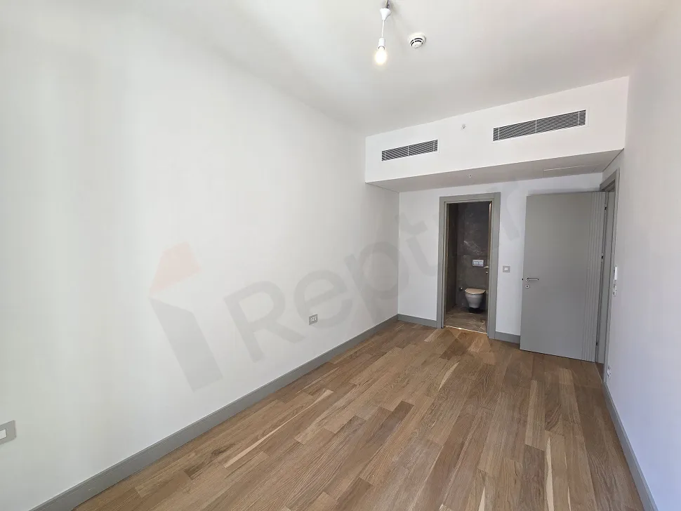 Modern tasarımlı, geniş ve aydınlık bir yatak odası iç mekanı.