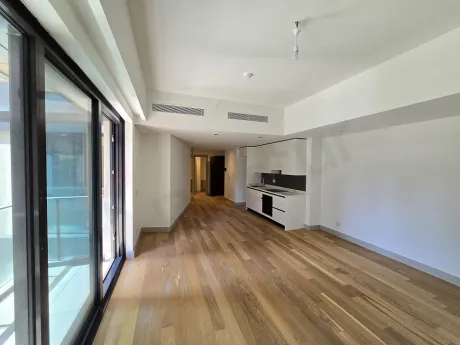 Modern ve geniş pencereli aydınlık bir oturma odası görünümü.