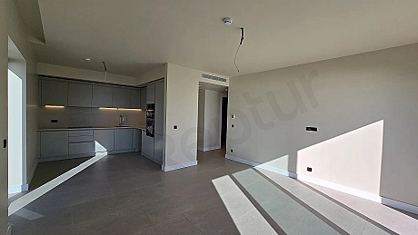 Bodrum'da satılık 2+1 rezidans dairenin geniş ve aydınlık oturma odası alanı.