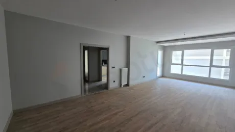 Geniş pencereli, ferah ve modern tasarımlı aydınlık oturma odası alanı.