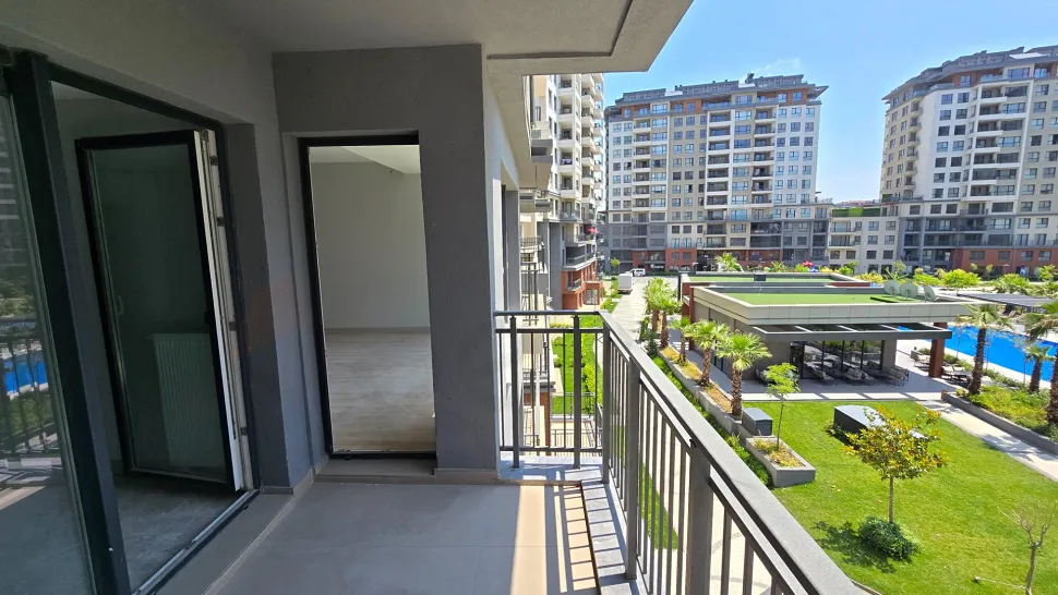 Modern bir dairenin geniş ve aydınlık balkon alanı görüntüsü.