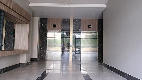 Modern asansör kabini iç mekanı, paslanmaz çelik detaylar ve aydınlatma