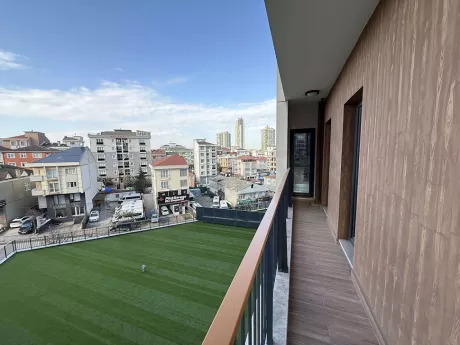 Modern bir apartman dairesinin geniş ve ferah balkonu.